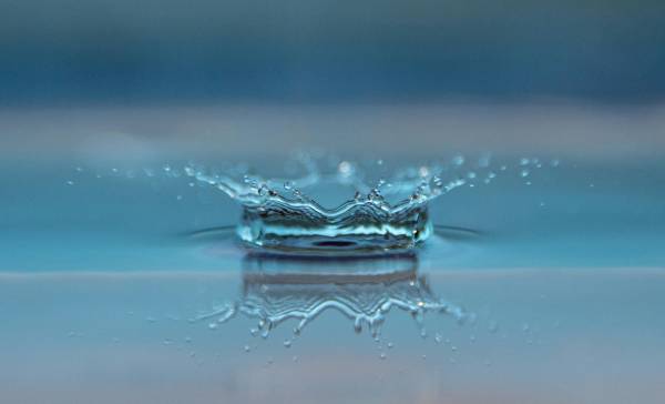 Water drop splashing into water